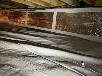 crawlspace covered in white plastic to protect from moisture and pests